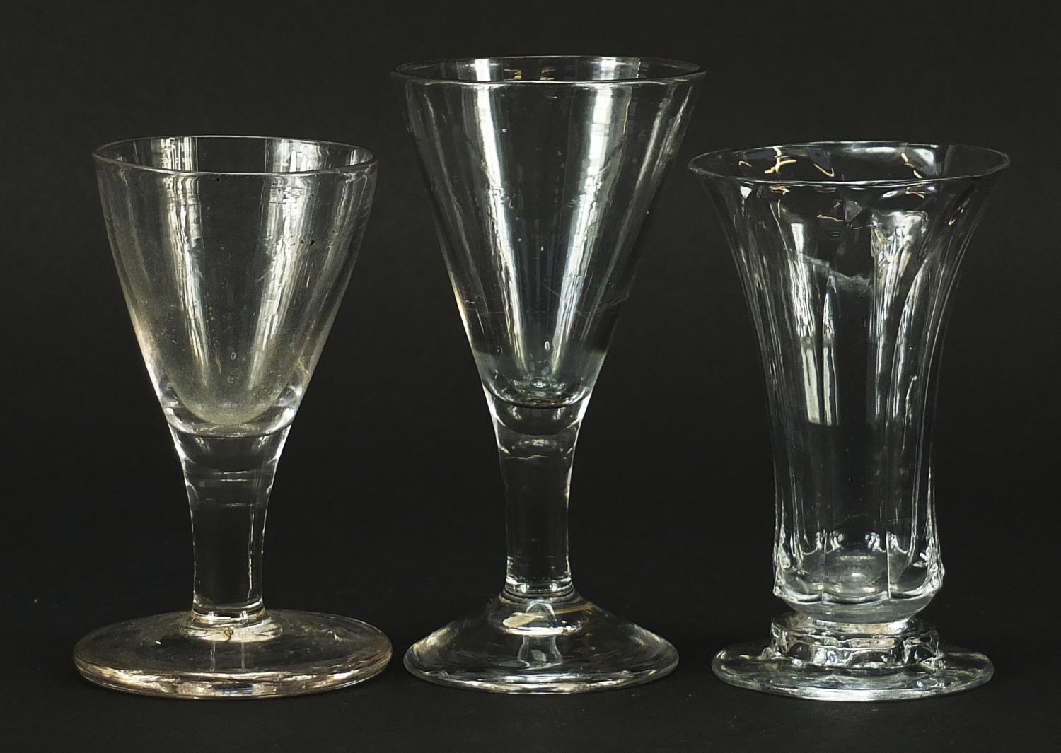 Three 18th century firing glasses, the largest 11.5cm high