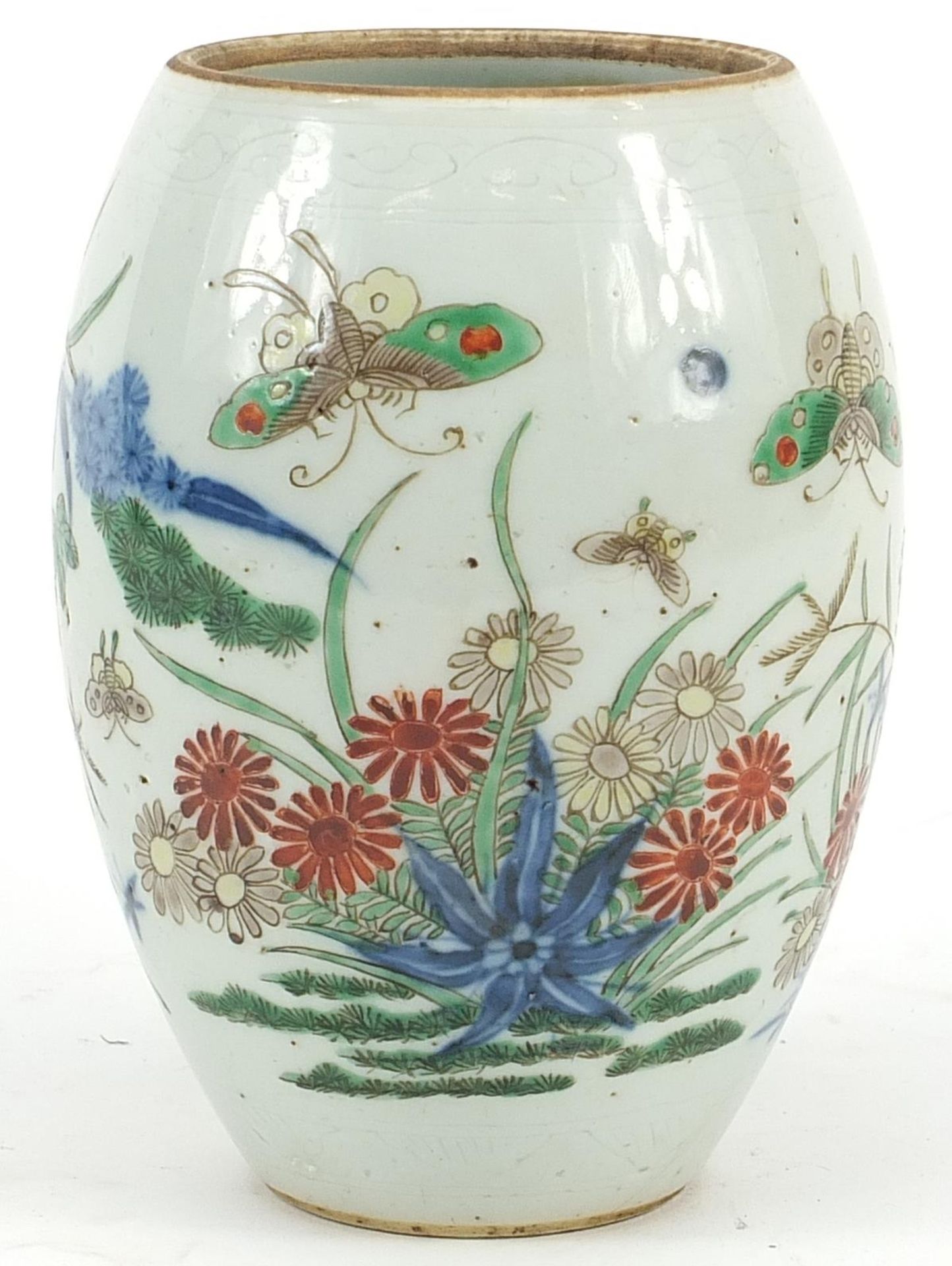 Chinese wucai porcelain vase hand painted with butterflies amongst flowers, 15cm high