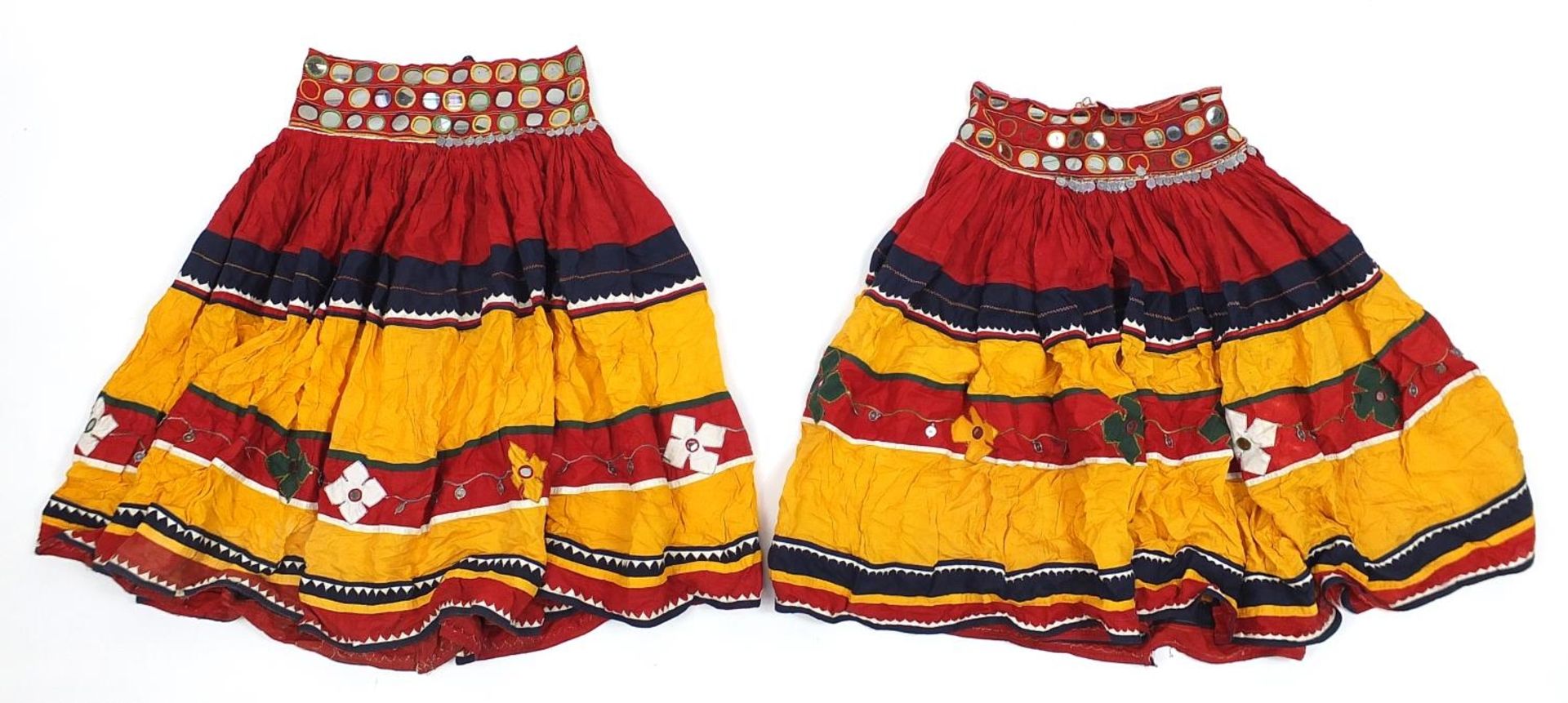 Two Middle Eastern or Indian mirrored embroidered skirts, possibly Banjara tribe, each 83cm high
