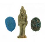Two Egyptian faience glazed scarab beetle beads and an Isis amulet, the largest 2.5cm high