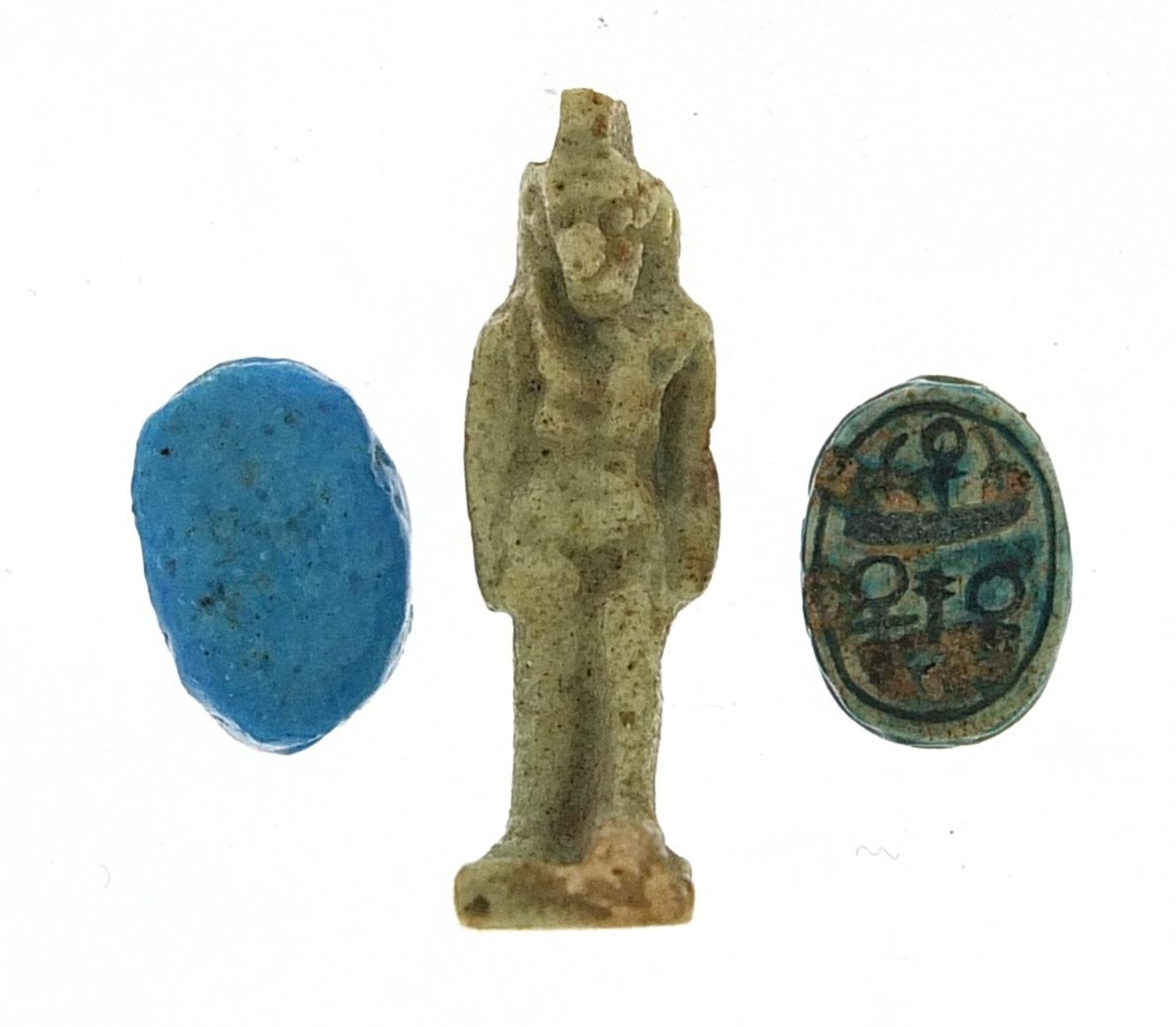 Two Egyptian faience glazed scarab beetle beads and an Isis amulet, the largest 2.5cm high