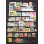 World stamps arranged in an album including mint, Cinderella and fiscal examples