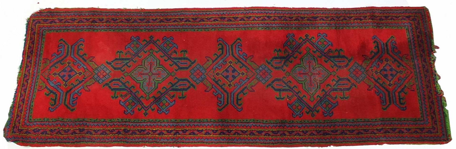 Middle Eastern red ground carpet runner, 275cm x 95cm