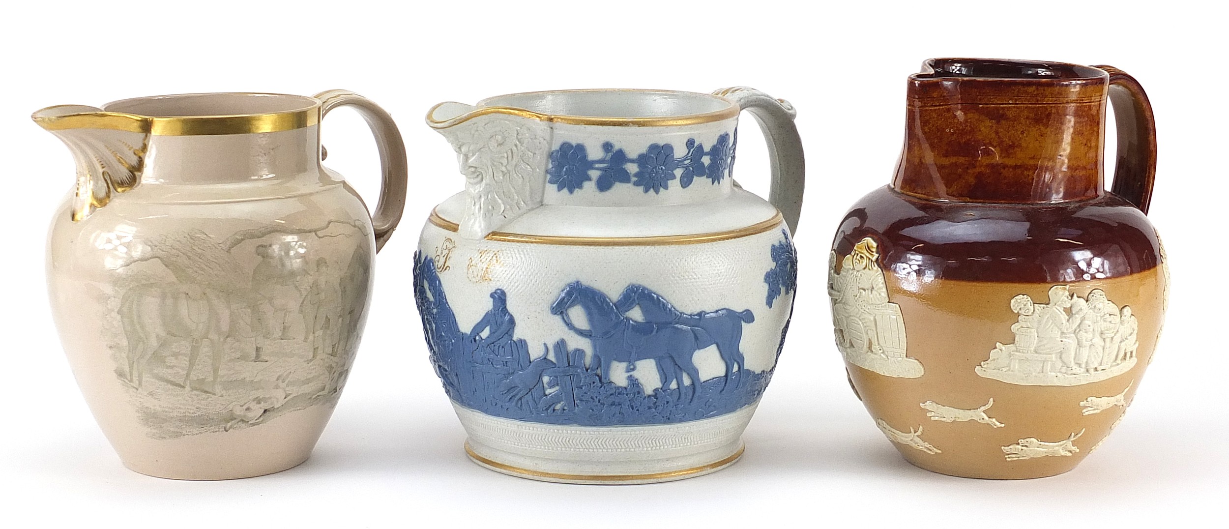 Three 19th century and later hunting interest jugs including an example with applied sprigging,