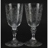 Pair of Edwardian wine glasses etched with leaves and berries, each 18.5cm high