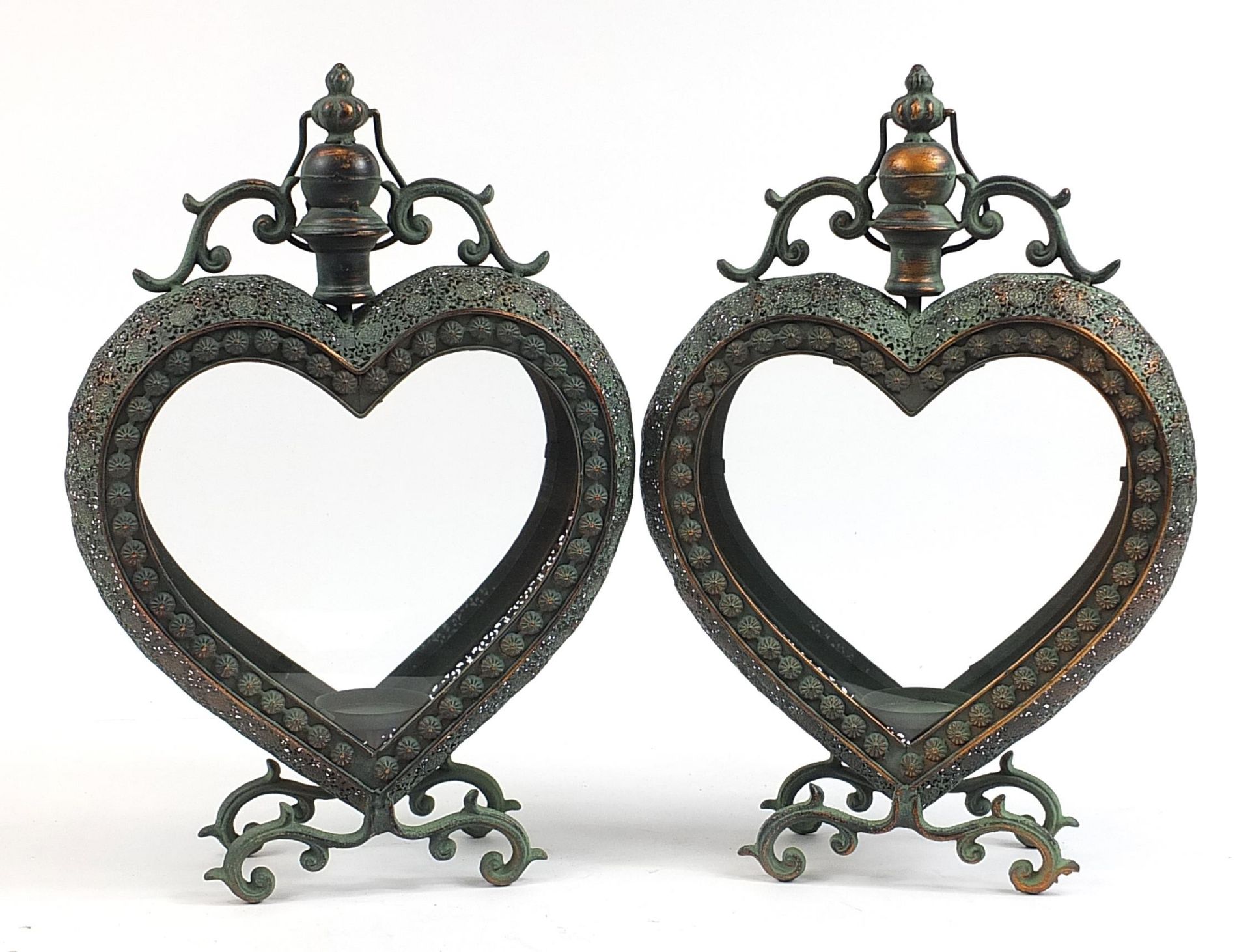 Pair of ornate bronzed metal love heart candle holders with glass panels, 53cm high