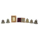 Objects comprising set of five bronze bells, photograph housed in a tooled leather case and a