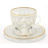 Continental glass cup and saucer with enamelled decoration, the saucer 12cm in diameter