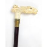 Hardwood walking stick with carved bone monkey and horse head handle, 87cm in length