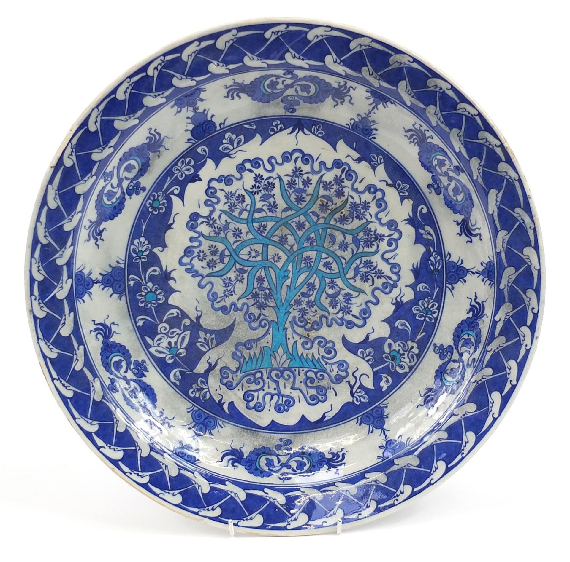Turkish Iznik pottery charger hand painted with stylised tree amongst flowers, 41cm in diameter