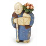 Japanese carved ivory netsuke of an Elder carrying fruit by Ichiro Inada, signed to the reverse, 6c