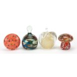 Four glass paperweights including Mdina, the largest 12cm high