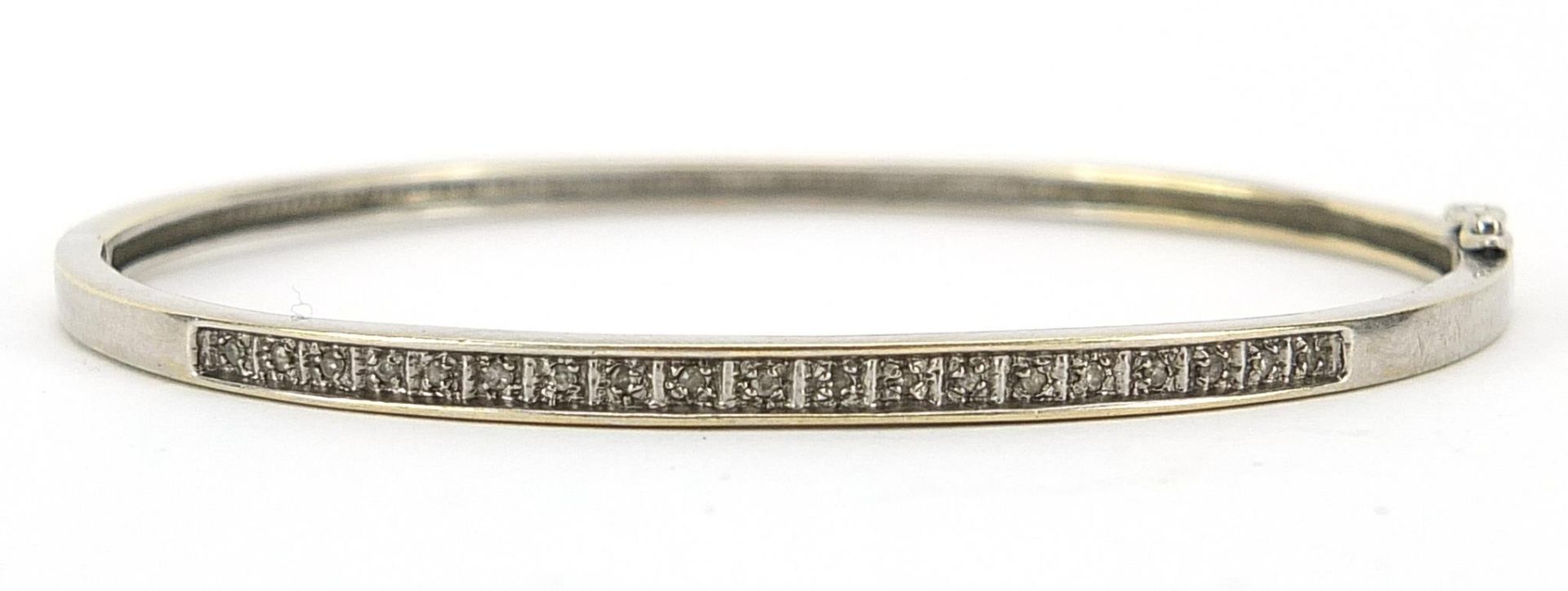 9ct white gold diamond hinged bangle housed in an Arcade Jewellers box, 6.2cm wide, 7.2g