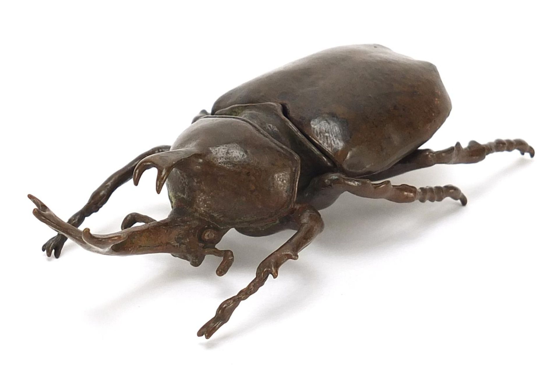 Large Japanese patinated bronze rhinoceros beetle with articulated body, impressed marks, 10cm in