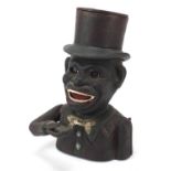 Painted cast iron money bank in the form of a jolly man, 21cm high