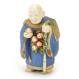 Japanese carved ivory netsuke of an Elder with a staff hold fruit by Ichiro Inada, signed to the