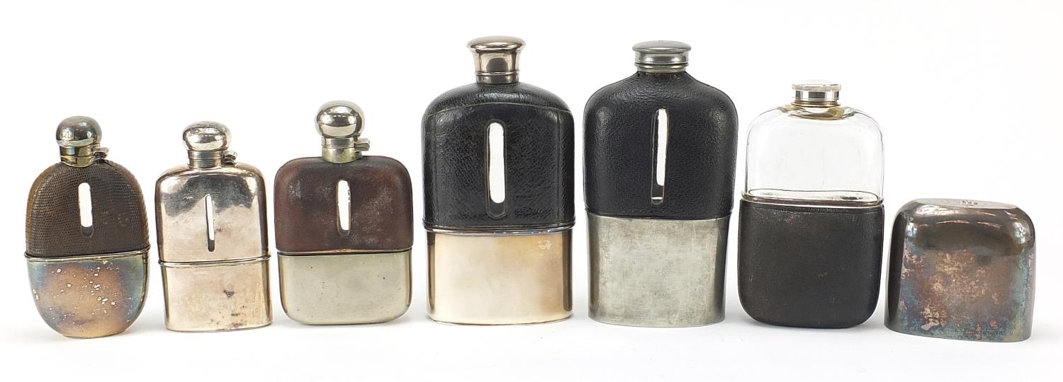 Six antique and later hip flasks, five with leather mounts, the largest 18cm high