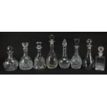 Eight glass decanters with stoppers including Caithness, the largest 33cm high