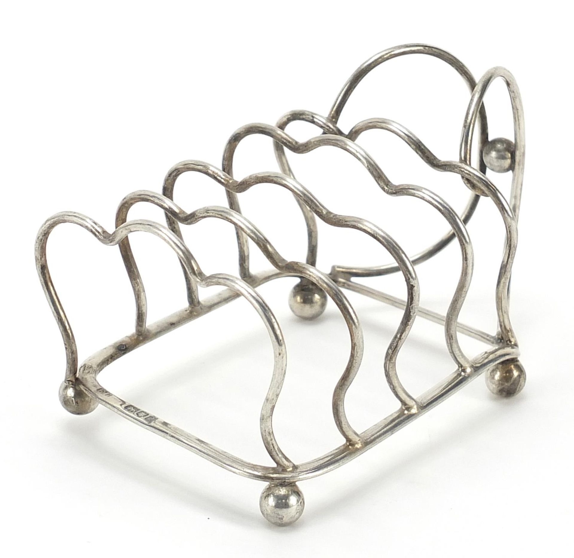 George Unite & Sons, Edward VII silver four slice toast rack with ball feet, London 1904, 12cm in