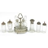 Glass bottle cruets including four Georgian and later with silver lids and a set of five on stand,