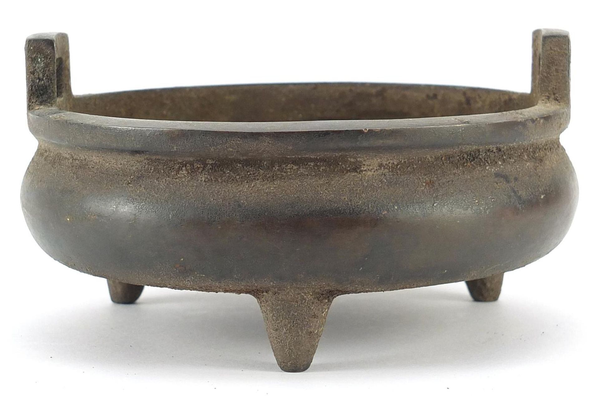 Chinese patinated bronze three footed censer with twin handles, six figure character marks to the - Image 2 of 4