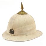British military World War II spike top pith helmet with cap badge, Ellwood's Cork helmet label to