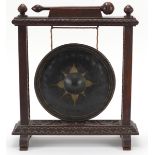 Early 20th century gong with oak frame profusely carved with foliage, 35cm high x 30.5cm wide