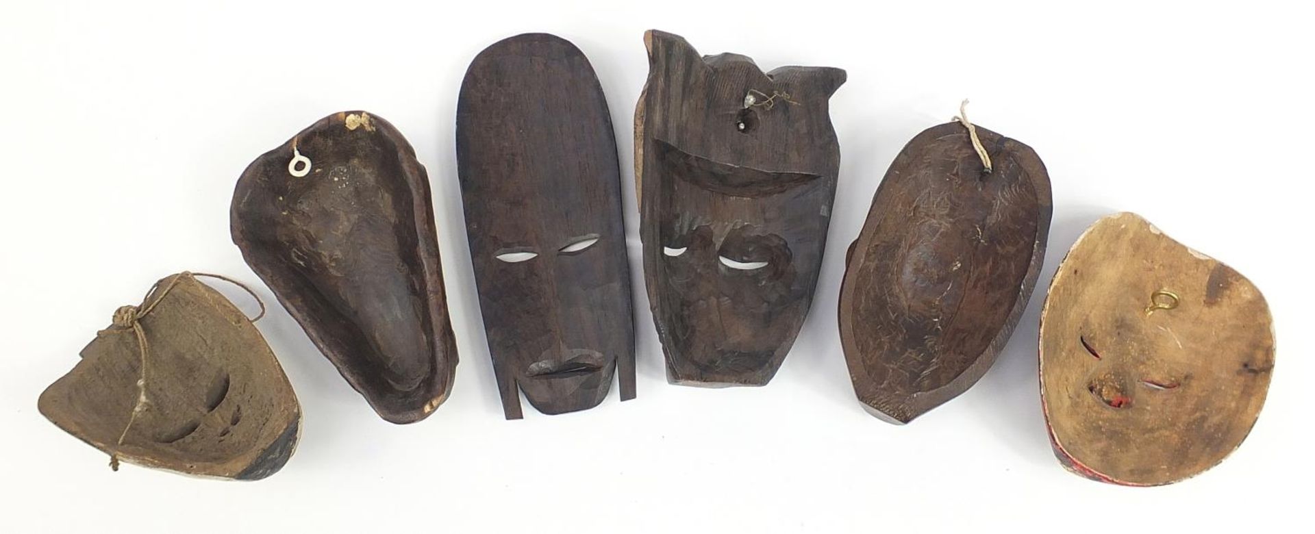 Six tribal interest carved wood face masks, the largest 31cm high - Image 4 of 4