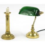 Brass banker's lamp with adjustable green glass shade and an antique brass candlestick, the