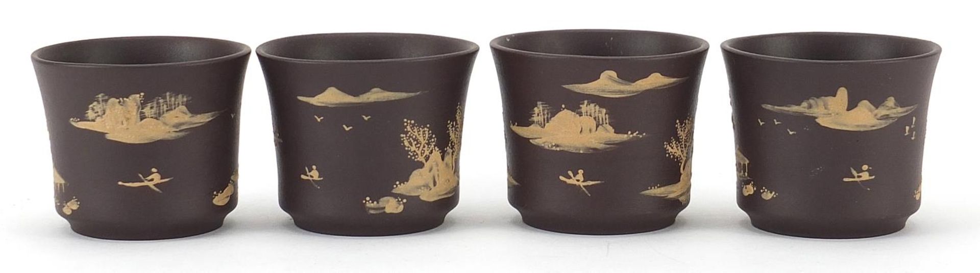 Four Chinese Yixing terracotta cups hand painted with landscapes, impressed character marks to the - Image 2 of 4