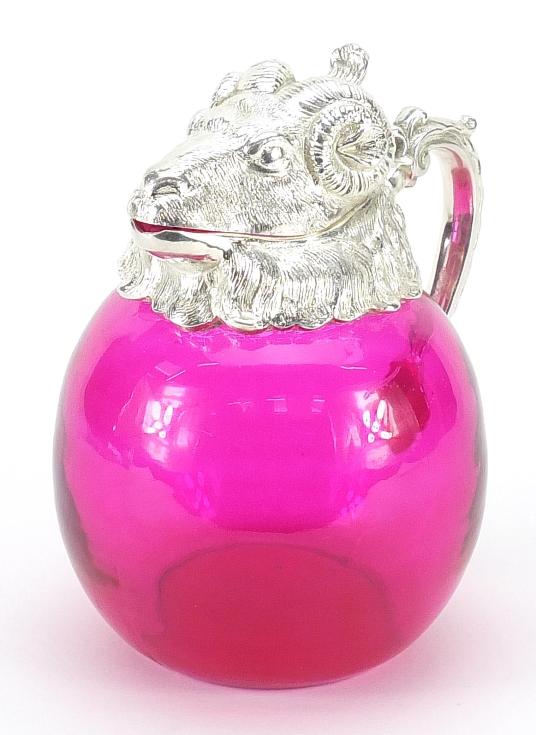 Silver plated and cranberry coloured glass jug in the form of a ram's head, 20cm high