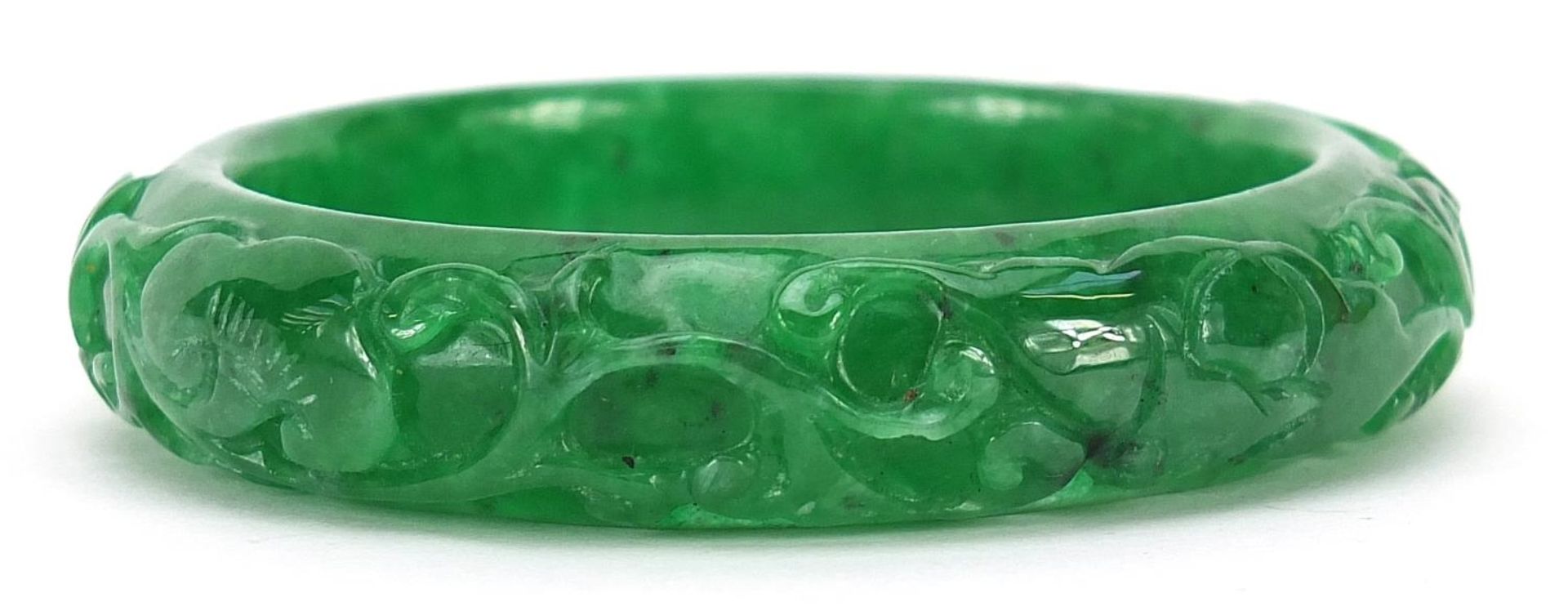 Chinese green jade bangle carved with a fish amongst aquatic foliage, 7cm in diameter, 56.7g - Image 2 of 2