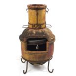 Large terracotta wood burner on stand, 95cm high