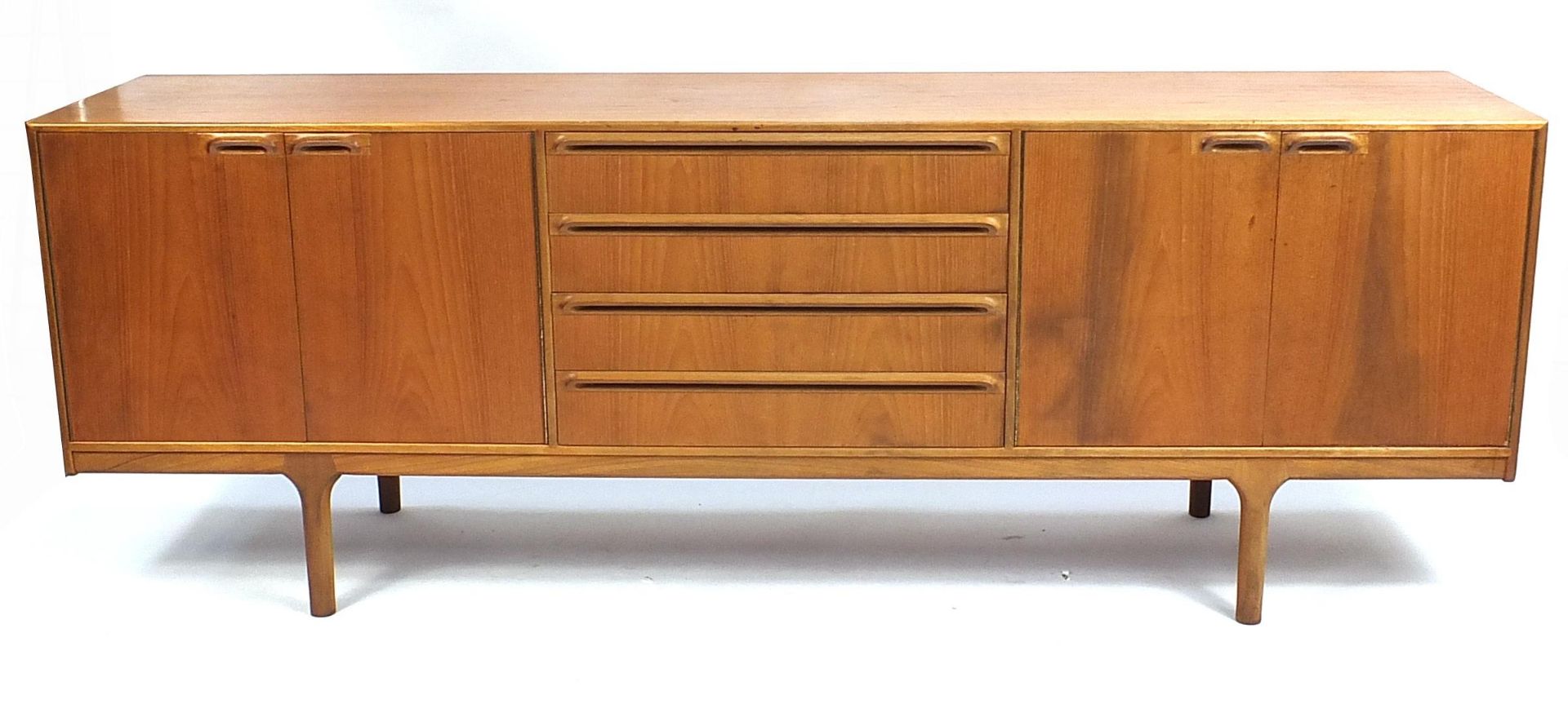 A H McIntosh & Co Ltd teak sideboard fitted with two pairs of cupboard doors and four central