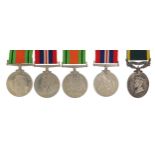 Five British military World War II medals including a three medal group with Territorial