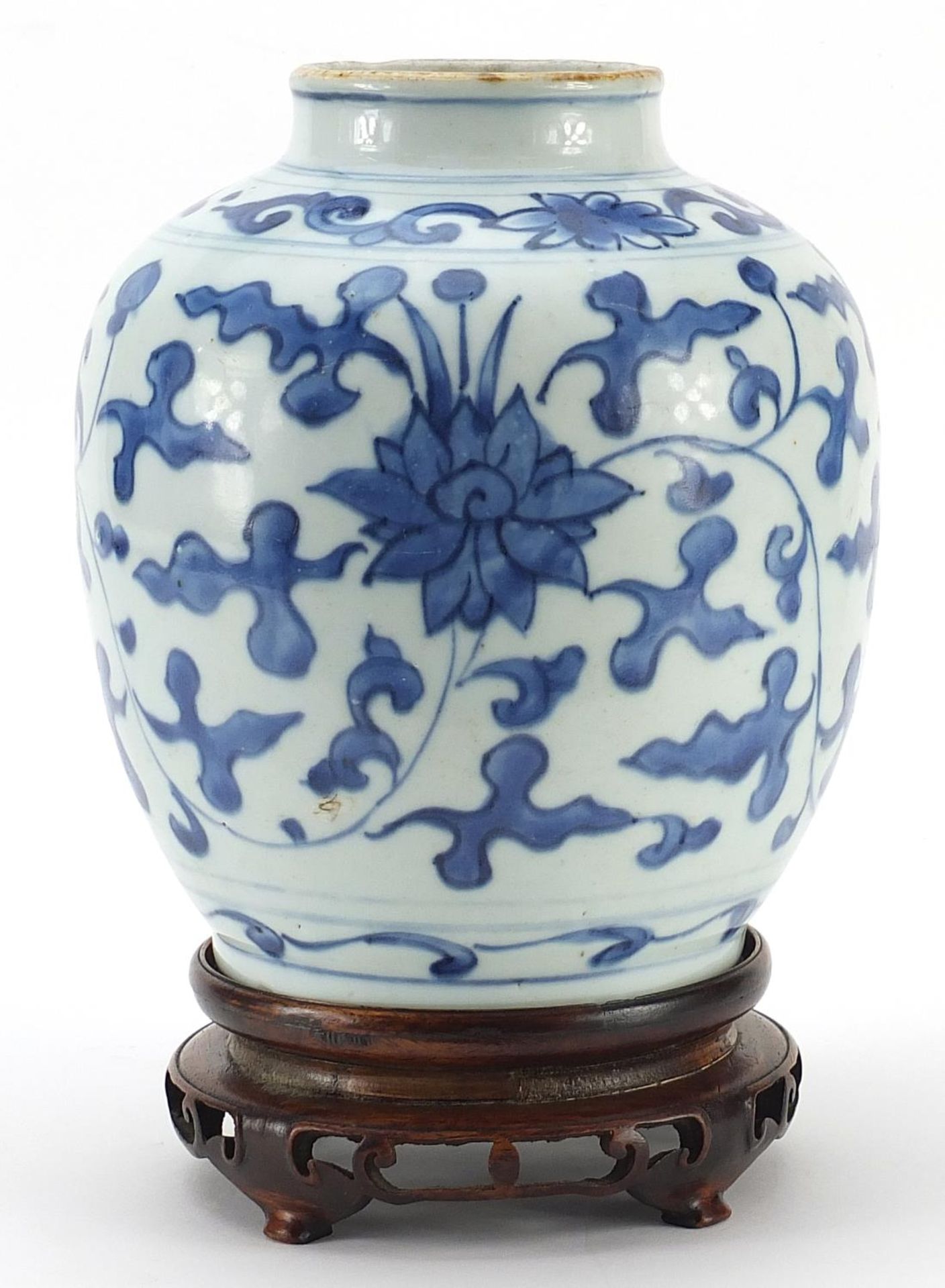 Chinese blue and white porcelain vase hand painted with flowers amongst foliage, raised on carved