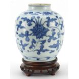 Chinese blue and white porcelain vase hand painted with flowers amongst foliage, raised on carved