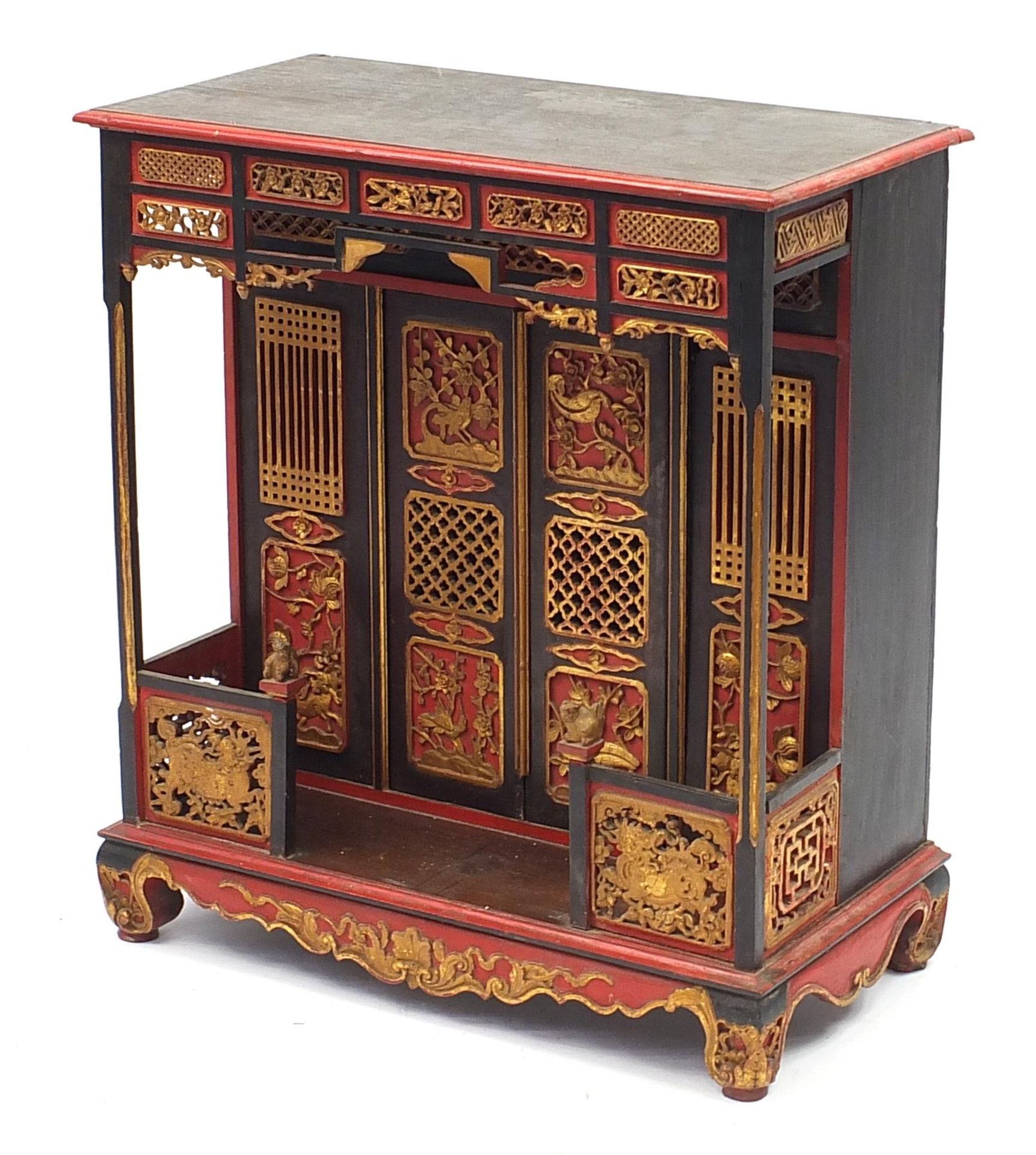 Chinese lacquered and giltwood shrine cabinet carved with mythical animals and birds amongst