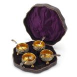 Set of four Victorian Gothic gilt metal open salts with spoons, housed in a fitted case, each 6.