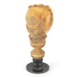 Early 19th century carved ivory desk seal in the form of a hand clutching a ball, 4.5cm high