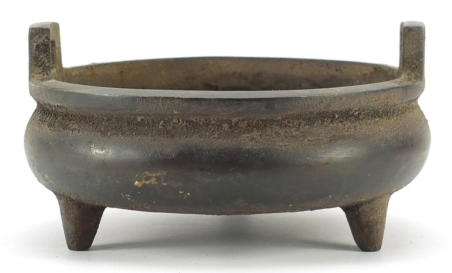 Chinese patinated bronze three footed censer with twin handles, six figure character marks to the