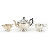 Art Deco silver three piece tea set comprising teapot with ebonised knop and handle, milk jug and