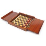 Victorian mahogany rosewood and boxwood folding chess board with part stained bone chess set