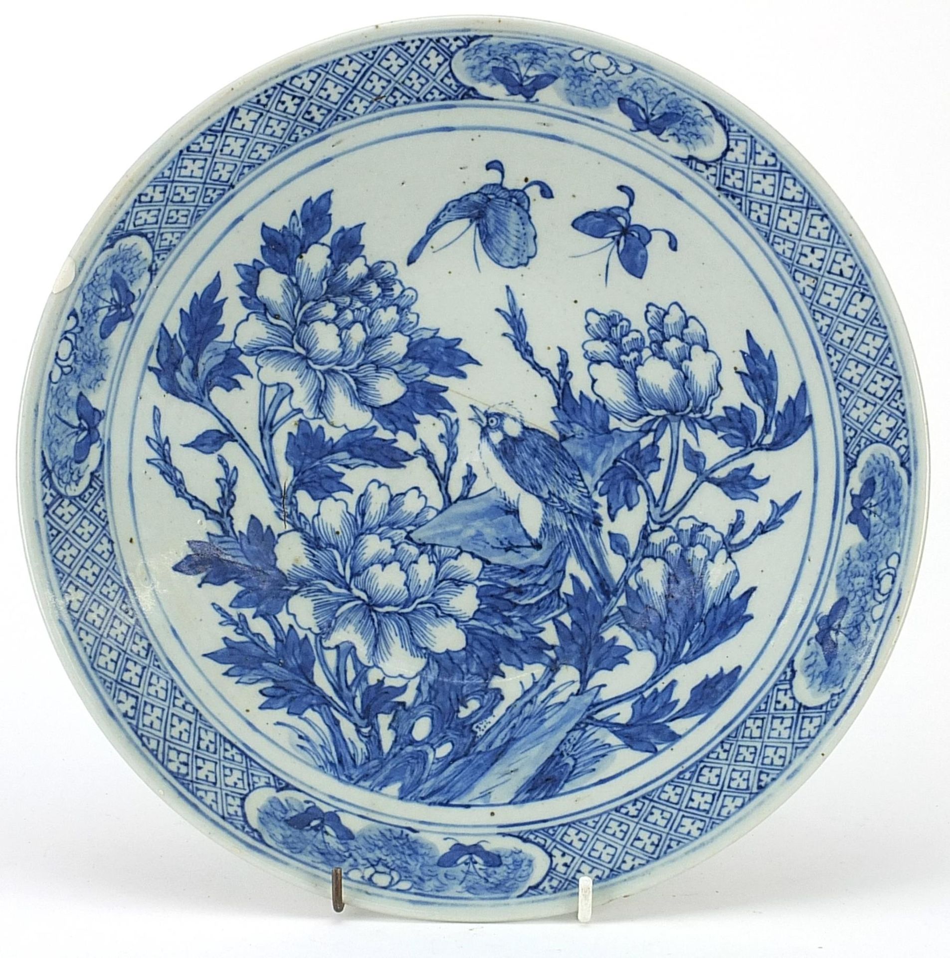 Chinese blue and white porcelain plate hand painted with a bird and butterflies amongst flowers,