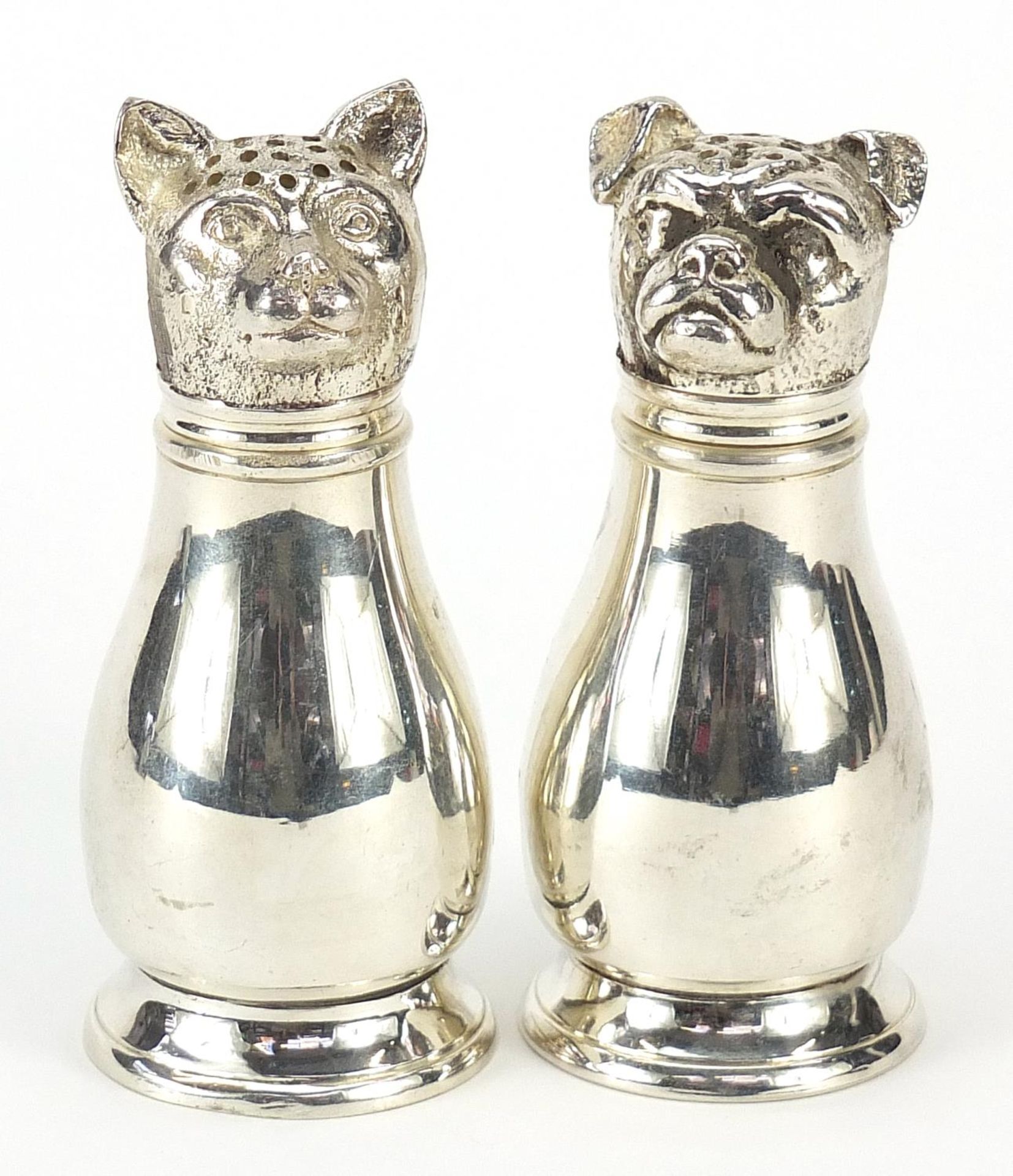 Pair of novelty silver plated cat and dog casters, 11cm high