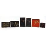 Five Japanese lacquered trays hand painted with animals and flowers including a red example with