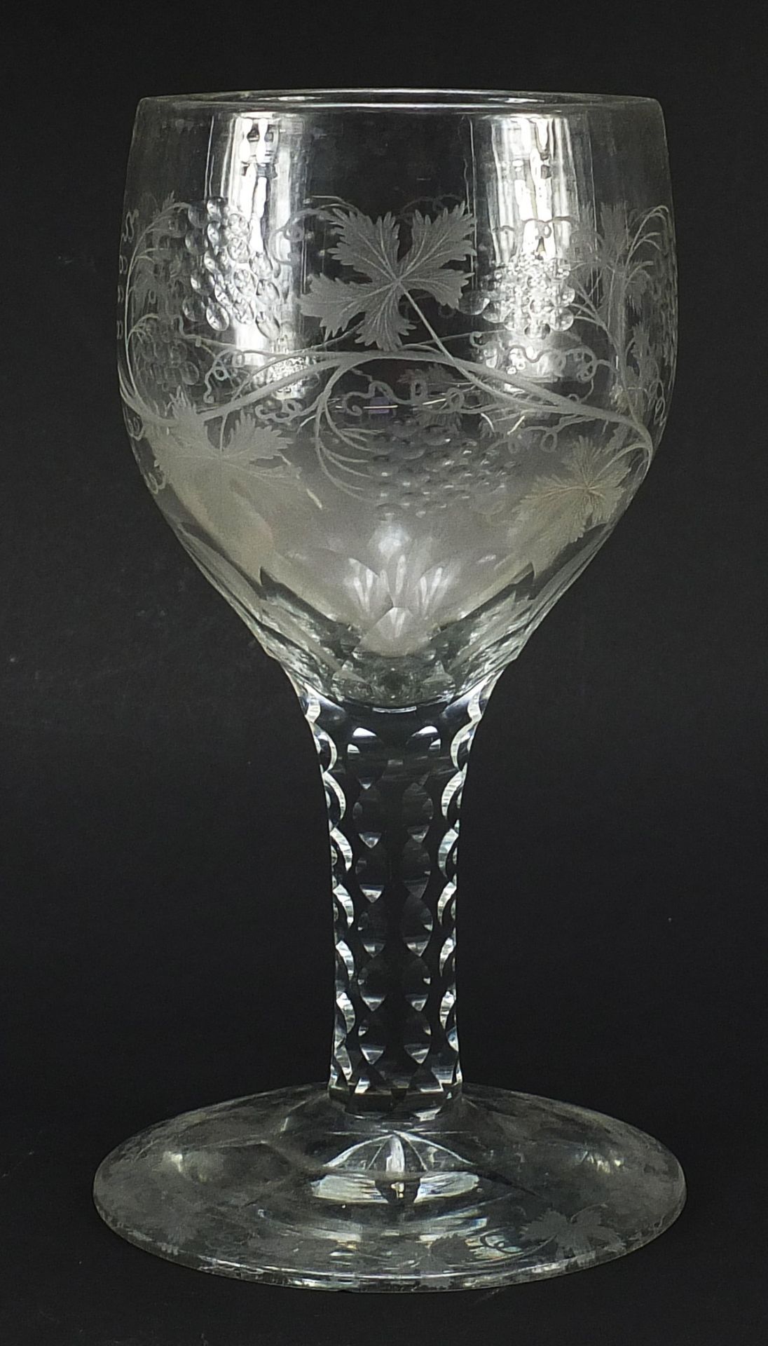 Large 18th century glass goblet with facetted stem etched with leaves and berries, 25cm high