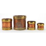 Graduated set of four 19th century copper and brass grain measures by The Oriental Metal Pressing