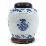 Chinese blue and white porcelain ribbed jar with cover raised on hardwood stand, hand painted with