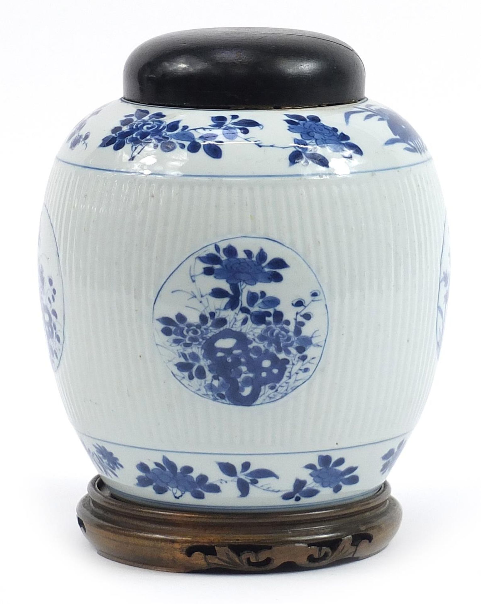 Chinese blue and white porcelain ribbed jar with cover raised on hardwood stand, hand painted with
